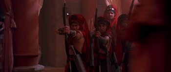 Movie still from “The Scorpion King” (2002), directed by Chuck Russell – A group of men in red robes holding arrows; Medium shot, High angle