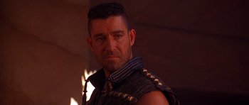 Movie still from “The Scorpion King” (2002), directed by Chuck Russell – A person wearing a vest; Close Up shot, Over the shoulder angle