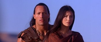 Movie still from “The Scorpion King” (2002), directed by Chuck Russell – A man and a woman standing next to each other; Close Up shot, Over the shoulder angle