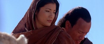 Movie still from “The Scorpion King” (2002), directed by Chuck Russell – A woman in a brown dress and a man in a blue shirt; Close Up shot, Low angle