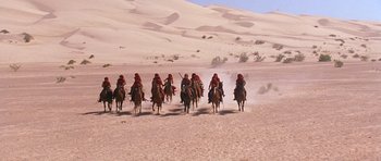 Movie still from “The Scorpion King” (2002), directed by Chuck Russell – A group of people riding on the backs of horses; Extreme Wide shot, High angle