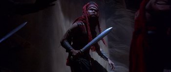 Movie still from “The Scorpion King” (2002), directed by Chuck Russell – A man with a sword in his hands; Medium shot, Low angle