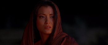 Movie still from “The Scorpion King” (2002), directed by Chuck Russell – A woman in a brown robe with a hood over her head; Close Up shot, Over the shoulder angle