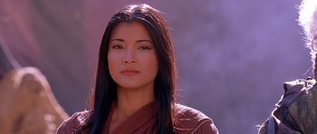 Movie still from “The Scorpion King” (2002), directed by Chuck Russell – A woman with long black hair wearing a brown shirt; Close Up shot, Low angle