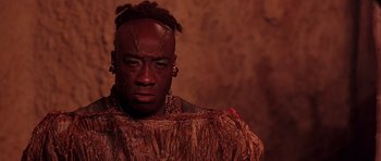 Movie still from “The Scorpion King” (2002), directed by Chuck Russell – A man in a costume with a piercing on his head; Close Up shot, Low angle