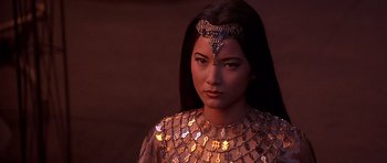 Movie still from “The Scorpion King” (2002), directed by Chuck Russell – A woman wearing a necklace and a gold chain around her neck; Close Up shot, High angle
