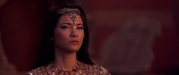 Movie still from “The Scorpion King” (2002), directed by Chuck Russell – A woman wearing a necklace and a gold necklace; Close Up shot, Over the shoulder angle