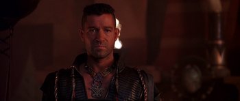 Movie still from “The Scorpion King” (2002), directed by Chuck Russell – A person wearing a necklace; Close Up shot, Over the shoulder angle