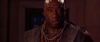 Movie still from “The Scorpion King” (2002), directed by Chuck Russell – A person wearing a necklace; Close Up shot, Low angle