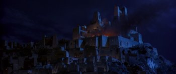 Movie still from “The Scorpion King” (2002), directed by Chuck Russell – A large building with a fire coming out of it's roof; Extreme Wide shot, Low angle