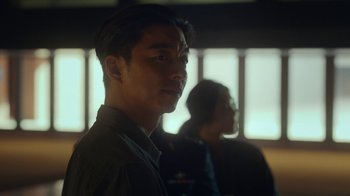 Movie still from “The Silent Sea” (2021), created by Choi Hang-Yong – A man standing next to another man in front of a window; Close Up shot, Over the shoulder angle