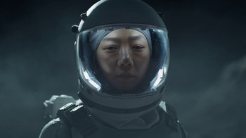 Movie still from “The Silent Sea” (2021), created by Choi Hang-Yong – A person wearing a space suit and a helmet; Close Up shot, Low angle