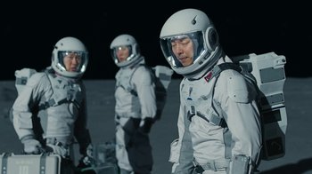 Movie still from “The Silent Sea” (2021), created by Choi Hang-Yong – A group of people in spacesuits standing on the moon; Medium shot, High angle