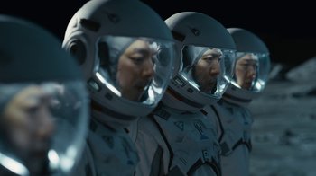 Movie still from “The Silent Sea” (2021), created by Choi Hang-Yong – A group of people in spacesuits are standing in a line; Medium shot, Low angle