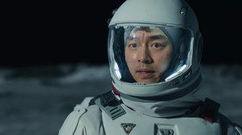 Movie still from “The Silent Sea” (2021), created by Choi Hang-Yong – A man wearing a space suit and a helmet; Close Up shot, Overhead angle