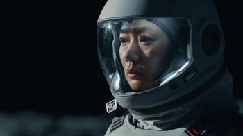 Movie still from “The Silent Sea” (2021), created by Choi Hang-Yong – A person wearing a space suit and a helmet; Close Up shot, Low angle
