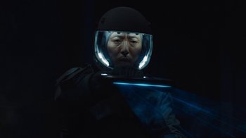 Movie still from “The Silent Sea” (2021), created by Choi Hang-Yong – A man wearing a helmet and a black jacket; Close Up shot, Low angle