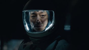 Movie still from “The Silent Sea” (2021), created by Choi Hang-Yong – A man wearing a space suit and a helmet; Close Up shot, Overhead angle