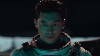 Movie still from “The Silent Sea” (2021), created by Choi Hang-Yong – A person wearing a space suit; Close Up shot, Overhead angle