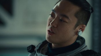 Movie still from “The Silent Sea” (2021), created by Choi Hang-Yong – A person wearing a headset; Close Up shot, Over the shoulder angle