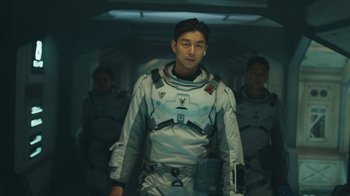 Movie still from “The Silent Sea” (2021), created by Choi Hang-Yong – A group of men standing next to each other in a room; Medium shot, Low angle