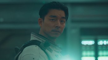 Movie still from “The Silent Sea” (2021), created by Choi Hang-Yong – A person wearing a white shirt and tie; Close Up shot, Low angle