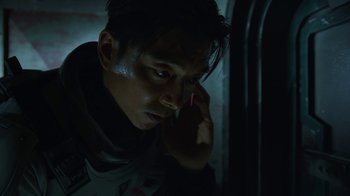 Movie still from “The Silent Sea” (2021), created by Choi Hang-Yong – A man is looking at his cell phone in the dark; Close Up shot, Low angle