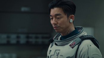 Movie still from “The Silent Sea” (2021), created by Choi Hang-Yong – A man in a spacesuit is looking to his left; Close Up shot, Over the shoulder angle