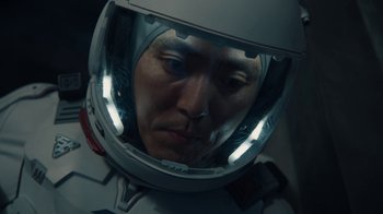 Movie still from “The Silent Sea” (2021), created by Choi Hang-Yong – A person wearing a space helmet; Close Up shot, High angle