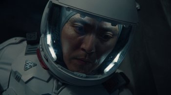 Movie still from “The Silent Sea” (2021), created by Choi Hang-Yong – A person wearing a space helmet; Close Up shot, High angle