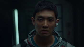 Movie still from “The Silent Sea” (2021), created by Choi Hang-Yong – A person wearing a space suit; Close Up shot, Low angle
