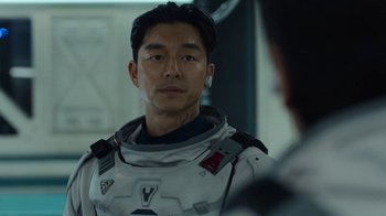 Movie still from “The Silent Sea” (2021), created by Choi Hang-Yong – A man in a spacesuit looking into a mirror; Close Up shot, Over the shoulder angle