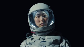 Movie still from “The Silent Sea” (2021), created by Choi Hang-Yong – A person wearing a spacesuit and helmet; Close Up shot, Low angle
