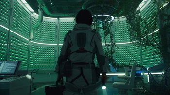 Movie still from “The Silent Sea” (2021), created by Choi Hang-Yong – A person in a space suit is holding a suitcase; Wide shot, Low angle