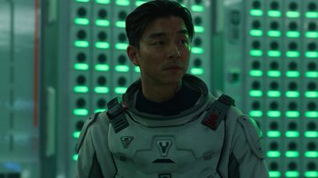 Movie still from “The Silent Sea” (2021), created by Choi Hang-Yong – A man in a spacesuit standing in front of a wall of lights; Close Up shot, Over the shoulder angle
