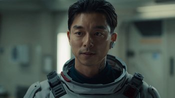 Movie still from “The Silent Sea” (2021), created by Choi Hang-Yong – A person wearing a space suit; Close Up shot, Over the shoulder angle