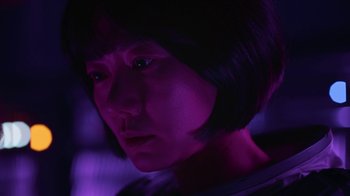 Movie still from “The Silent Sea” (2021), created by Choi Hang-Yong – A person with a purple light in the background; Close Up shot, Low angle