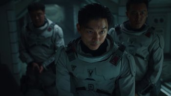 Movie still from “The Silent Sea” (2021), created by Choi Hang-Yong – A group of men in spacesuits standing next to each other; Close Up shot, Over the shoulder angle