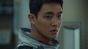 Movie still from “The Silent Sea” (2021), created by Choi Hang-Yong – A person wearing a space suit; Close Up shot, Over the shoulder angle
