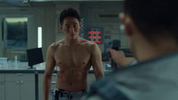 Movie still from “The Silent Sea” (2021), created by Choi Hang-Yong – A man taking a picture of another man in front of a mirror; Medium shot, Over the shoulder angle