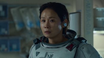 Movie still from “The Silent Sea” (2021), created by Choi Hang-Yong – A woman in a spacesuit is looking at the camera; Close Up shot, Over the shoulder angle