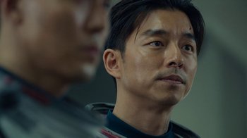 Movie still from “The Silent Sea” (2021), created by Choi Hang-Yong – A person looking at a camera; Close Up shot, Over the shoulder angle