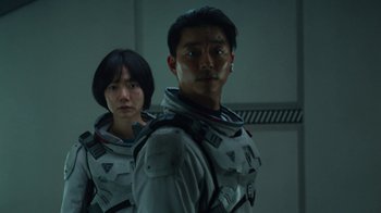 Movie still from “The Silent Sea” (2021), created by Choi Hang-Yong – A man and a woman standing next to each other; Close Up shot, Low angle