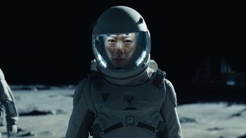 Movie still from “The Silent Sea” (2021), created by Choi Hang-Yong – A person in a spacesuit and helmet on the moon; Close Up shot, Low angle