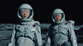 Movie still from “The Silent Sea” (2021), created by Choi Hang-Yong – A couple of people in spacesuits standing next to each other; Medium shot, Low angle
