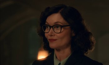 Movie still from “Guillermo del Toro's Cabinet of Curiosities” (2022), directed by Keith Thomas – A person wearing glasses and a suit; Close Up shot, Over the shoulder angle