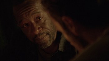 Movie still from “The Walking Dead” (2010), directed by Daniel Sackheim – An older man looking at the camera with his hand on his face; Close Up shot, Over the shoulder angle