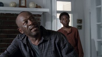 Movie still from “The Walking Dead” (2010), directed by Daniel Sackheim – A man and a boy standing in front of a window; Close Up shot, Over the shoulder angle