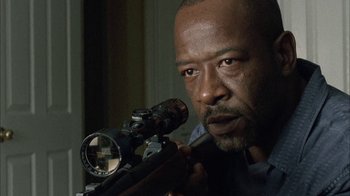 Movie still from “The Walking Dead” (2010), directed by Daniel Sackheim – A person holding a rifle; Close Up shot, Low angle