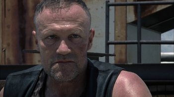 Movie still from “The Walking Dead” (2010), directed by Daniel Sackheim – A person wearing a leather vest; Close Up shot, Low angle